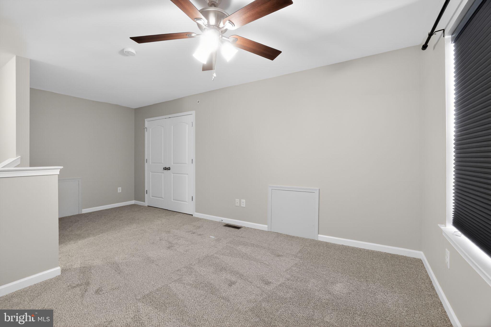 3669 Jacob Stout Road, Unit 8 Doylestown, PA 18902 - Photo 26 of 34 an empty room with a window and a fan