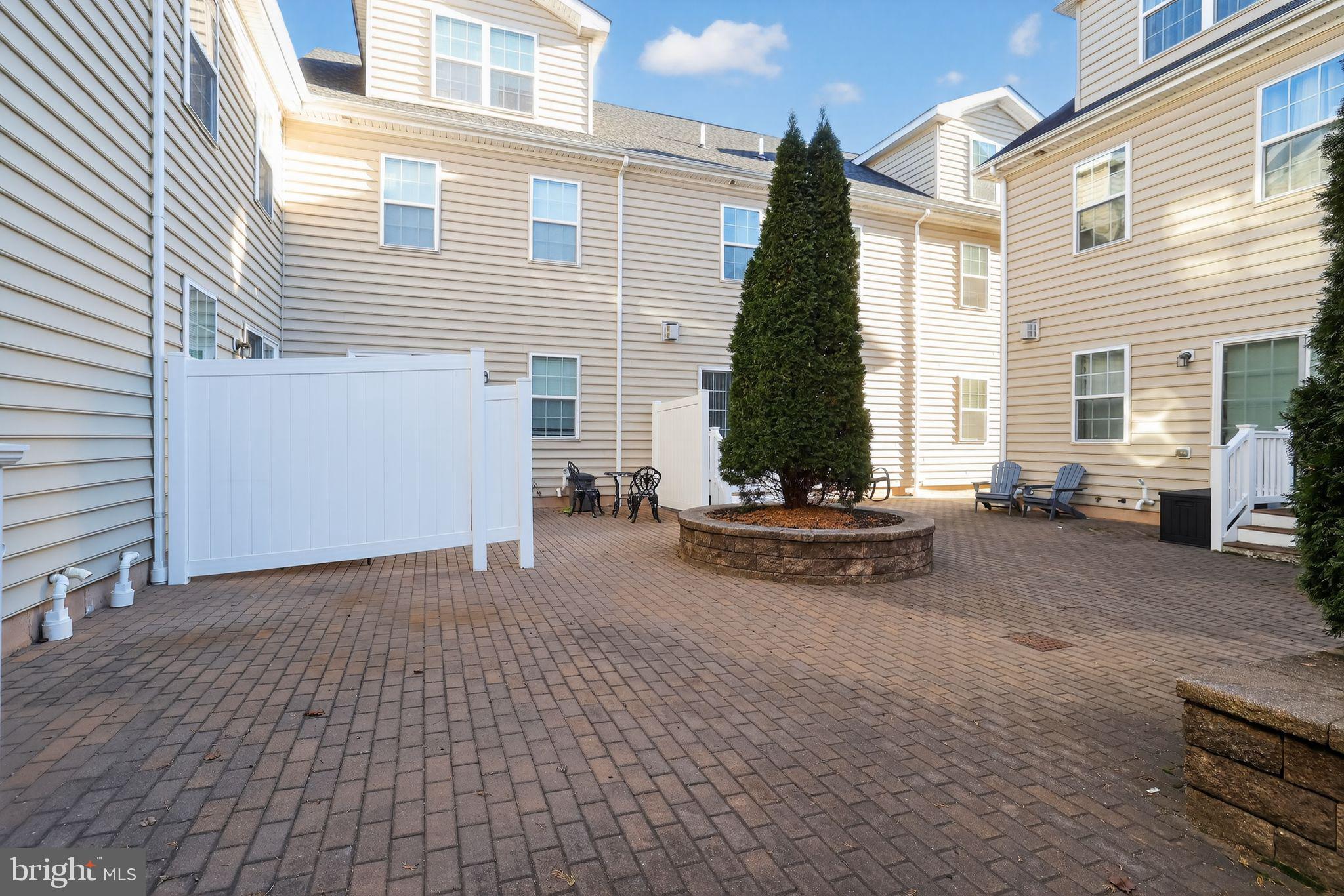 3669 Jacob Stout Road, Unit 8 Doylestown, PA 18902 - Photo 32 of 34 a view of a patio with a table and chairs and ice snow