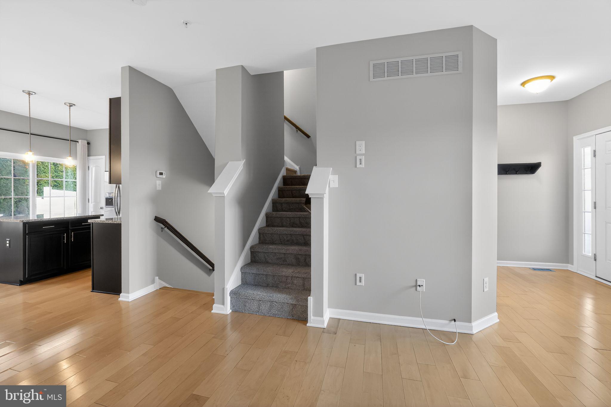 3669 Jacob Stout Road, Unit 8 Doylestown, PA 18902 - Photo 5 of 34 a view of a hallway with wooden floor and staircase