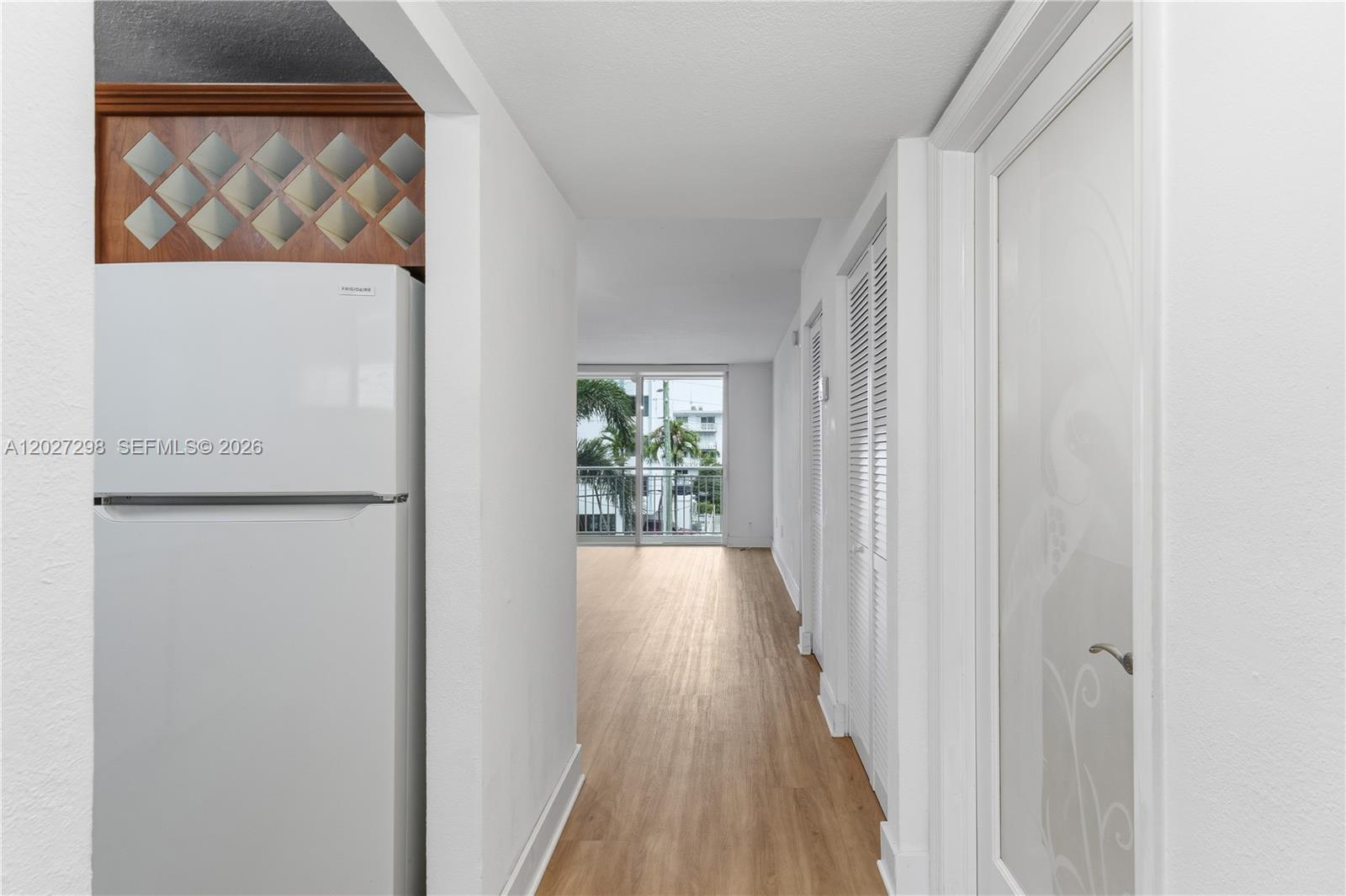 1665 Bay Road, Unit 322 Miami Beach, FL 33139 - Photo 4 of 24 a view of hallway with wooden floor