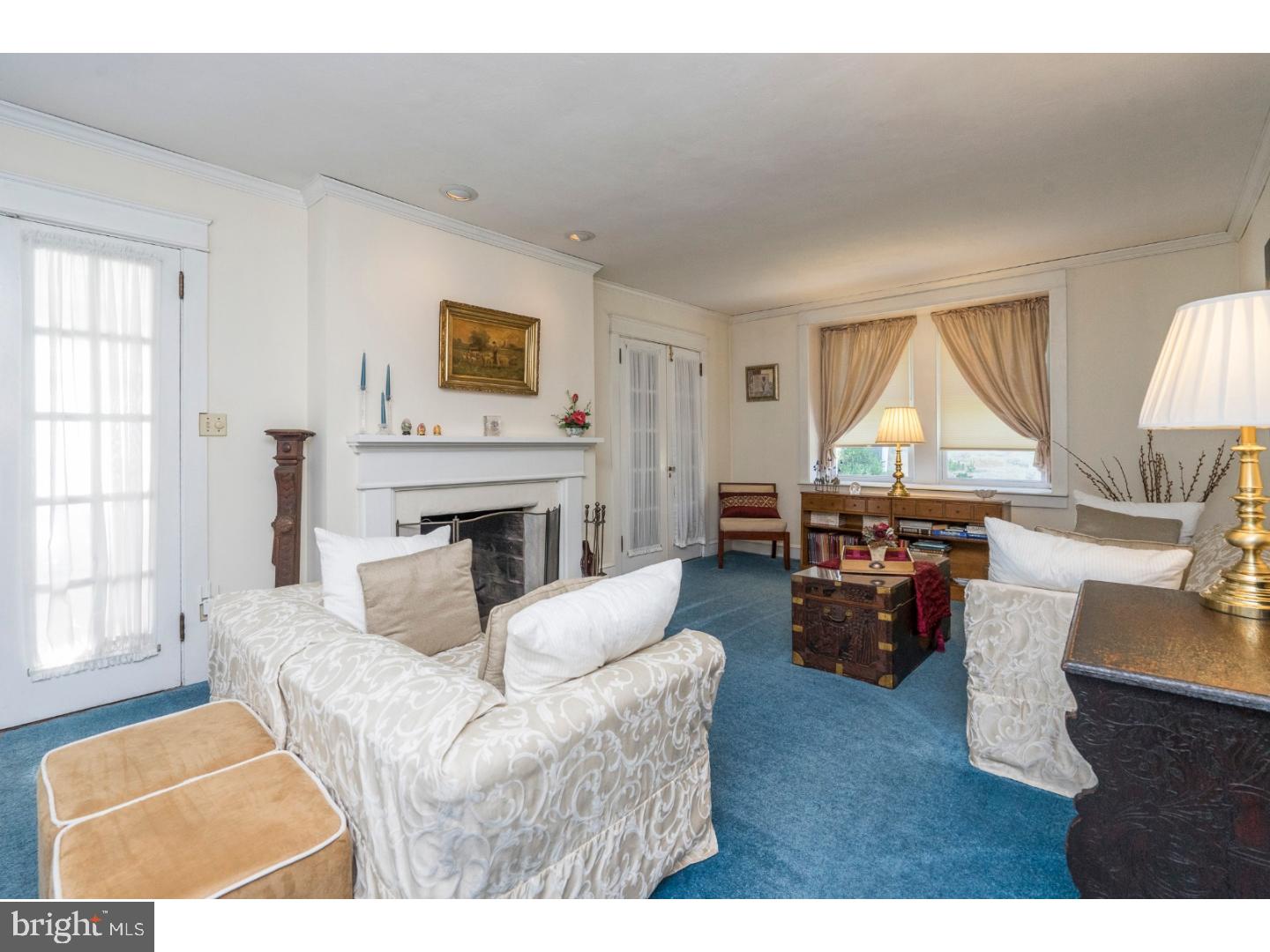 417 Netherwood Road Upper Darby, PA 19082 - Photo 3 of 24 a living room with furniture a fireplace and a large window
