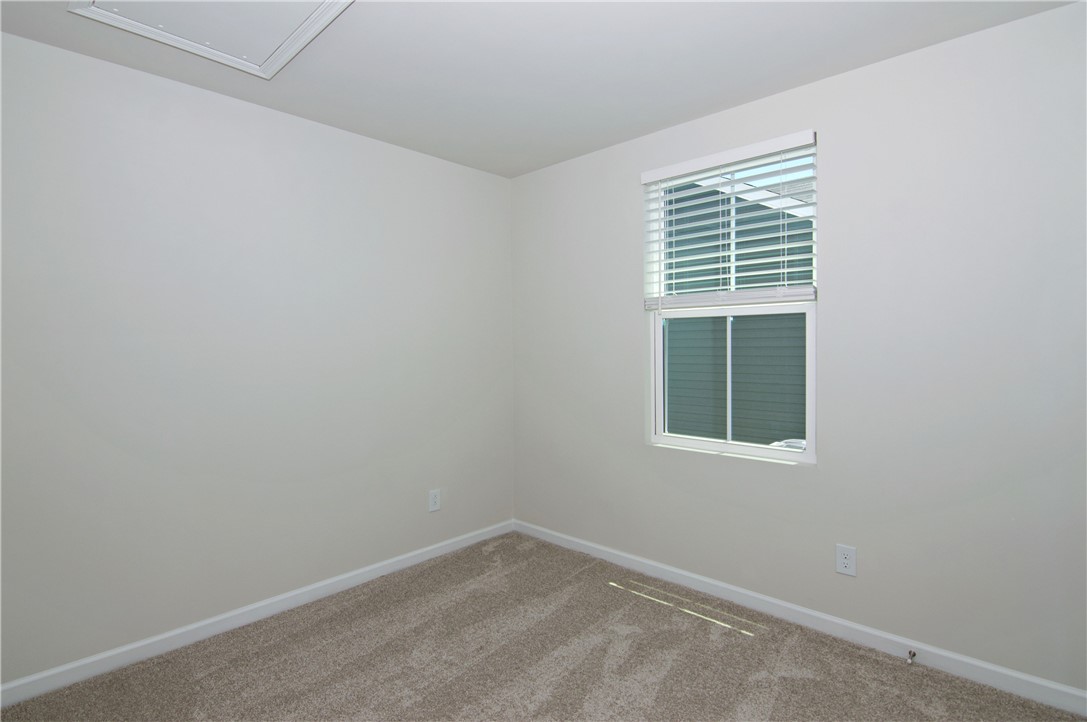 723 Peridot Way Westminster, SC 29693 - Photo 25 of 45 A well-lit, quiet room awaits customization, offering plush carpet and natural illumination through its window.