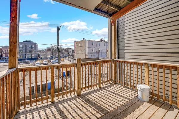 a view of a balcony with wooden floor