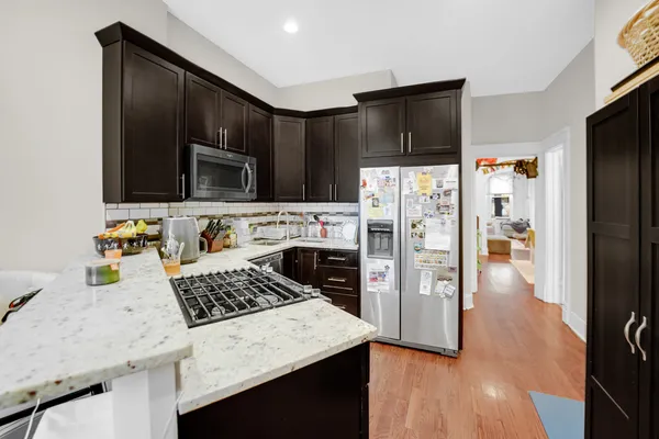 a kitchen with stainless steel appliances a stove a microwave and sink