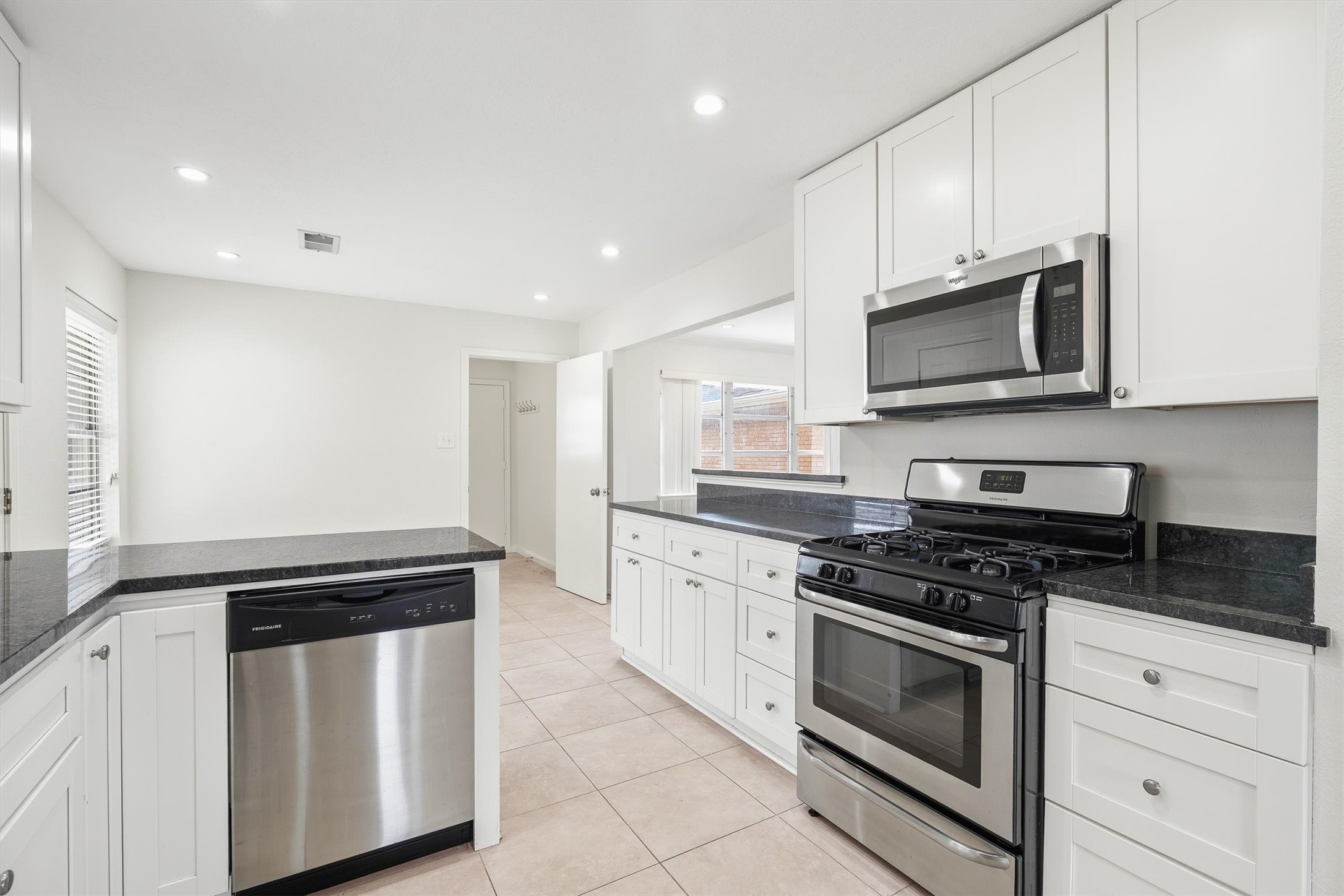 3331 Arbor Street Houston, TX 77004 - Photo 8 of 30 This modern kitchen features has ample storage and counter space, with a bright, open layout enhanced by recessed lighting and a window providing natural light.