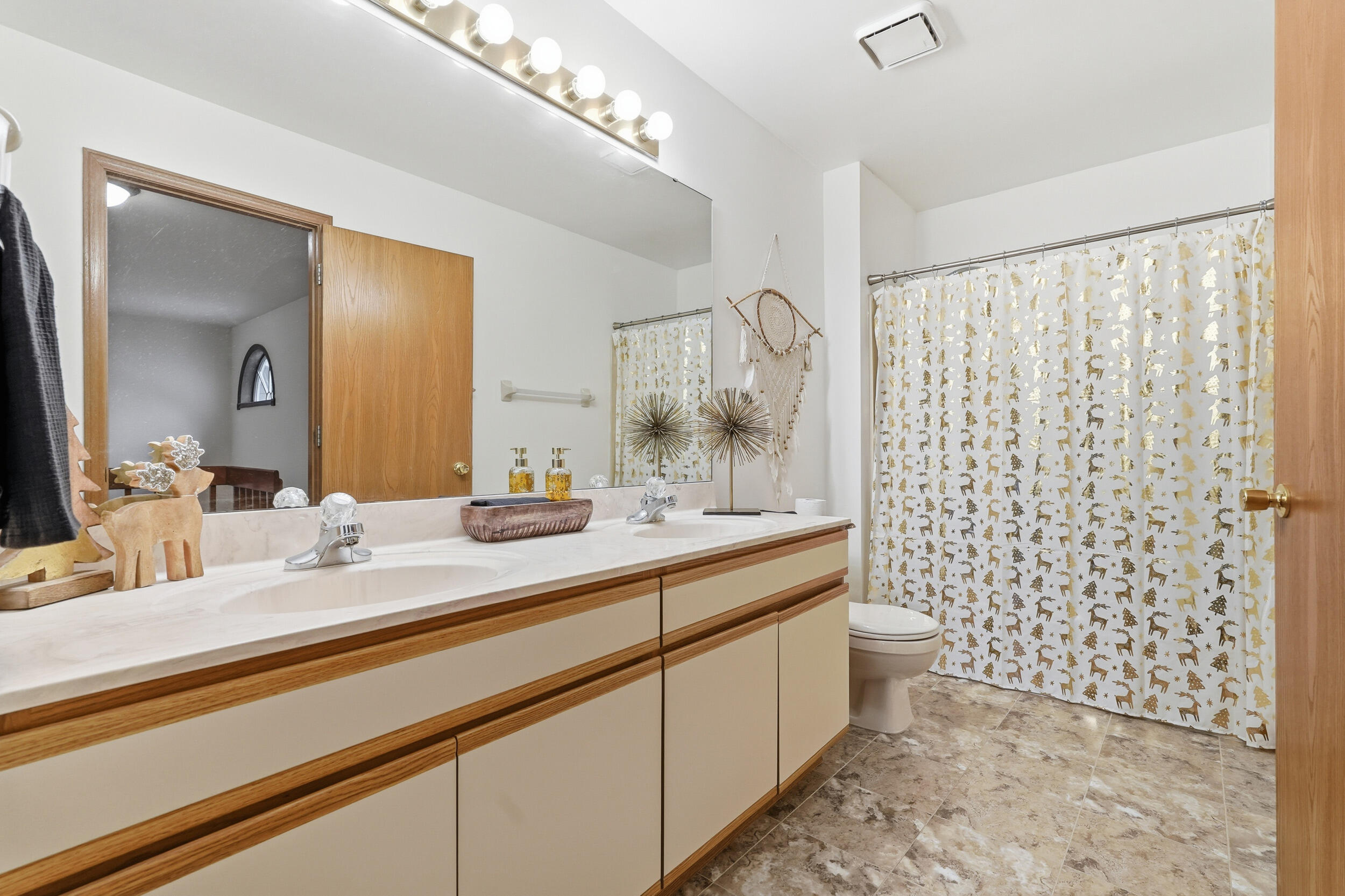 9465 Van Buren Court Crown Point, IN 46307 - Photo 11 of 16 a bathroom with a double vanity sink toilet and a mirror