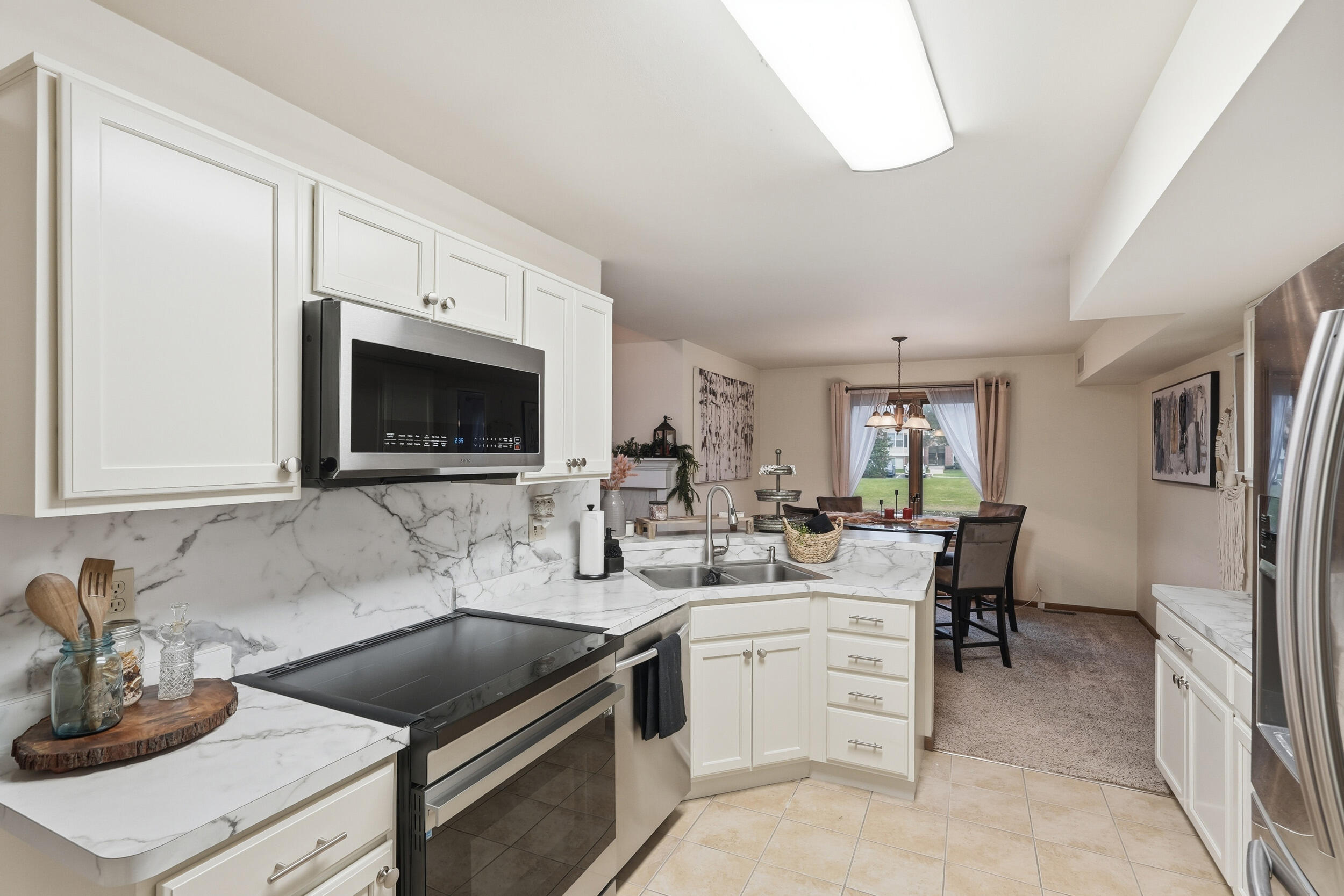 9465 Van Buren Court Crown Point, IN 46307 - Photo 4 of 16 a kitchen with a sink stove and microwave