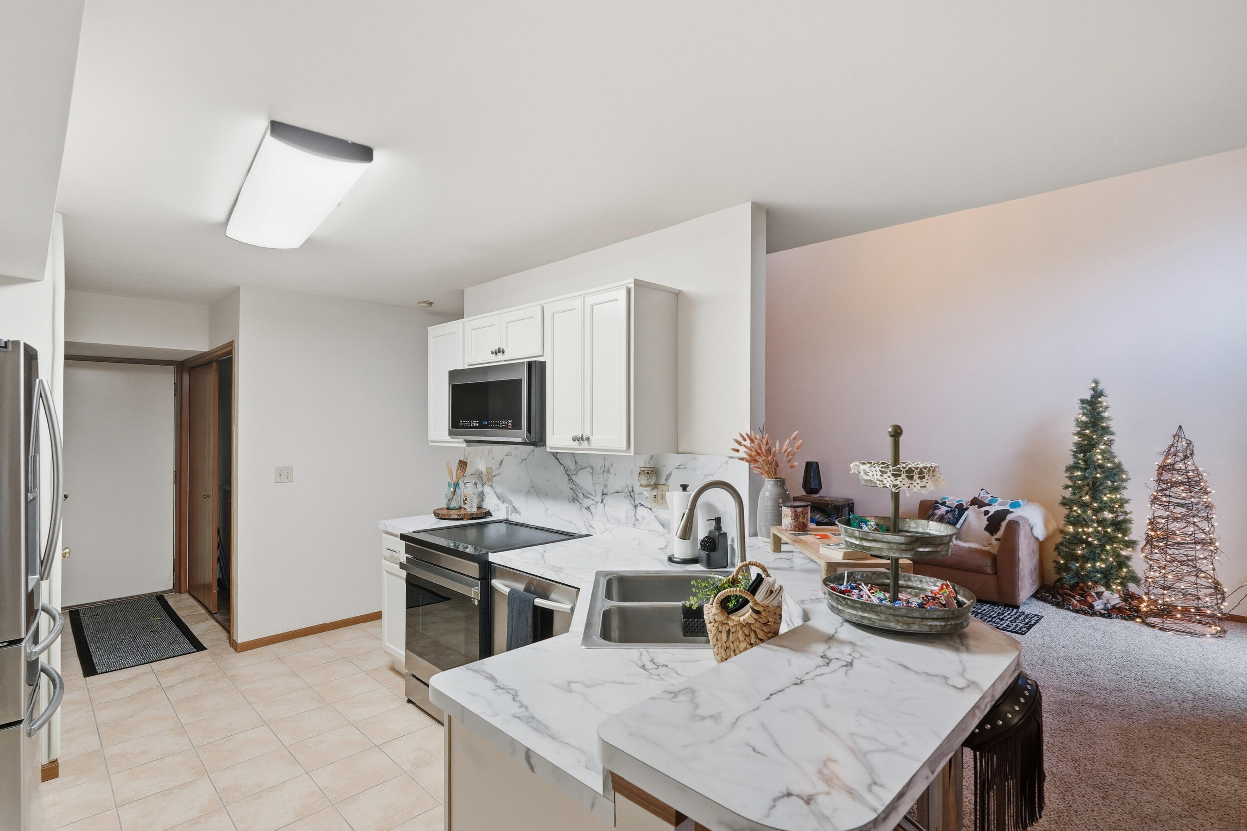 9465 Van Buren Court Crown Point, IN 46307 - Photo 5 of 16 a dining room with furniture and a flat screen tv