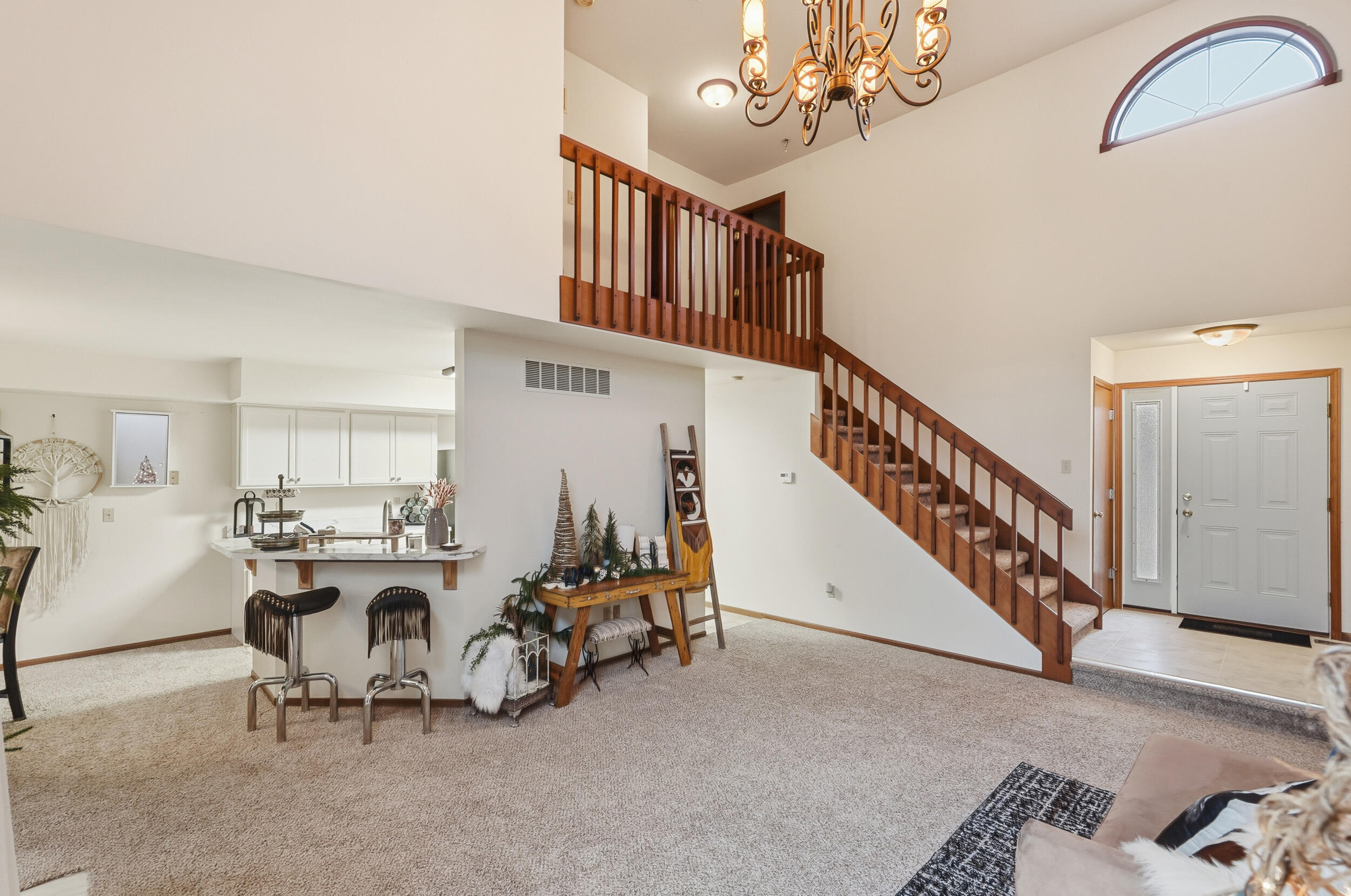 9465 Van Buren Court Crown Point, IN 46307 - Photo 8 of 16 a view of a livingroom with furniture a fireplace chandelier and windows