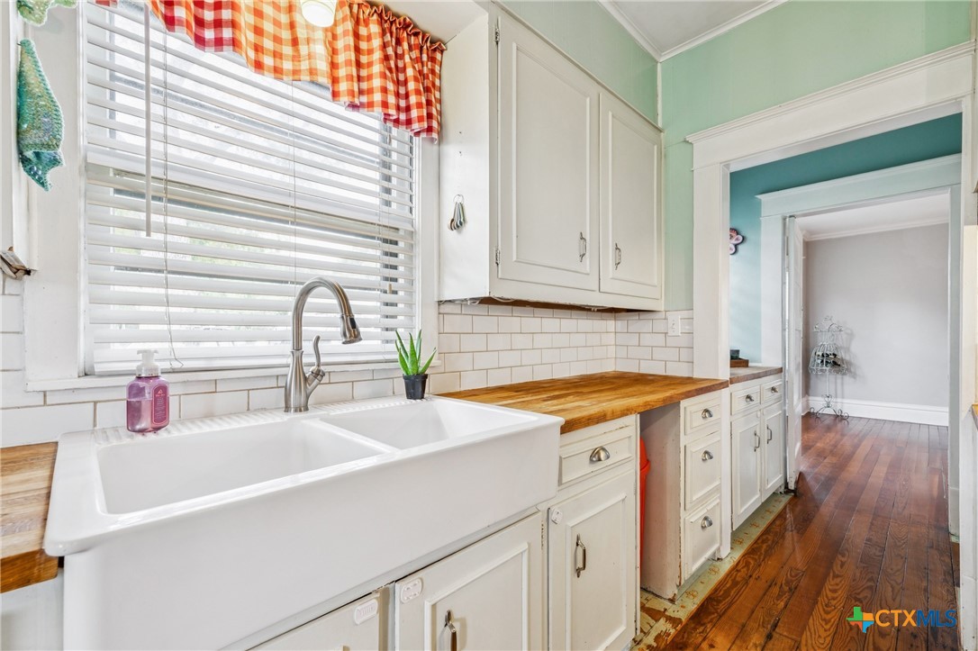 1004 Mitchell Street Gonzales, TX 78629 - Photo 14 of 46 a kitchen with stainless steel appliances granite countertop a sink and a stove