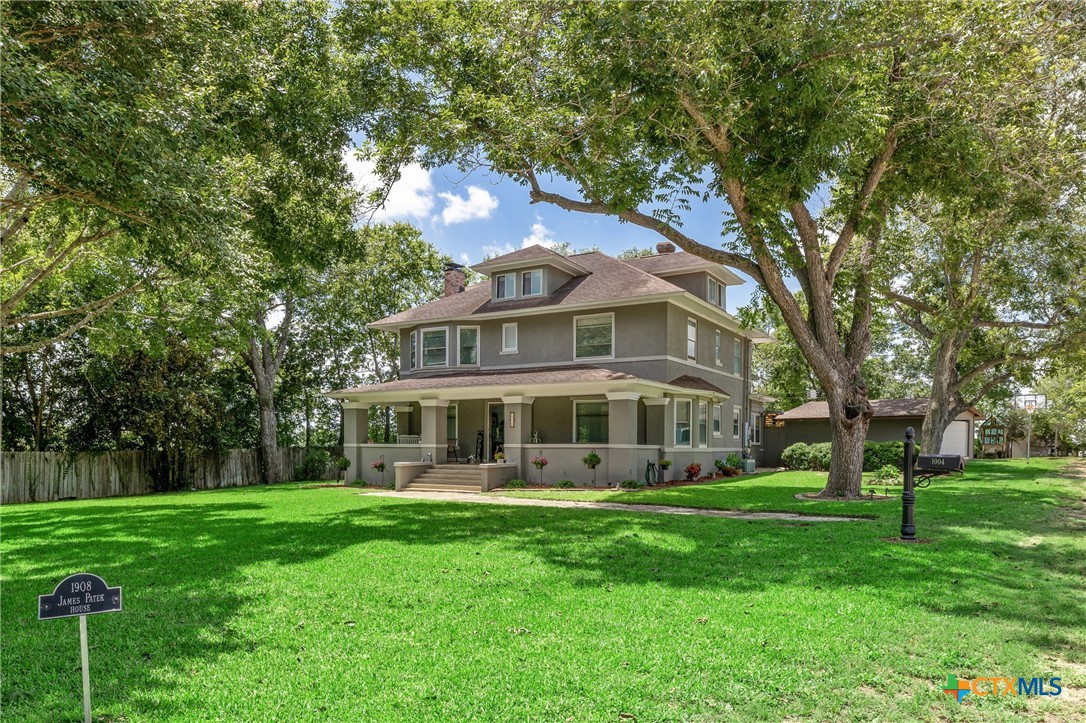 1004 Mitchell Street Gonzales, TX 78629 - Photo 2 of 46 a front view of a house with a yard
