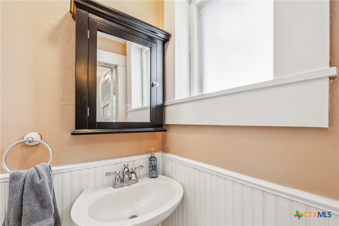 1004 Mitchell Street Gonzales, TX 78629 - Photo 21 of 46 a bathroom with a sink and a mirror