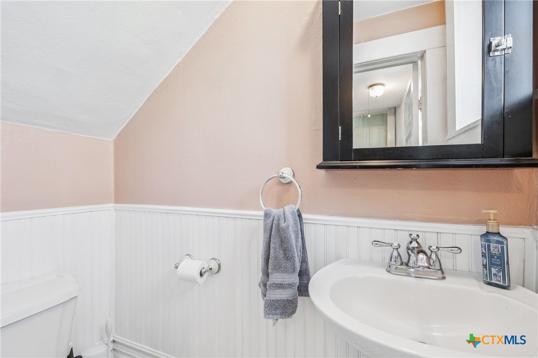 1004 Mitchell Street Gonzales, TX 78629 - Photo 22 of 46 a bathroom with a sink and a mirror