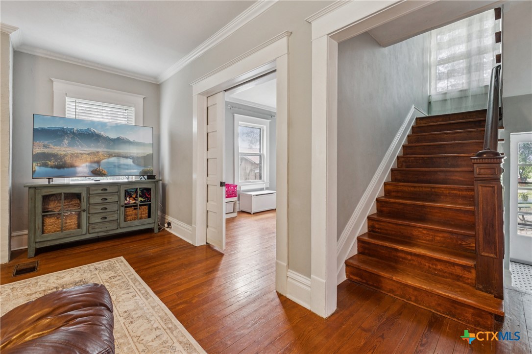 1004 Mitchell Street Gonzales, TX 78629 - Photo 23 of 46 a view of a livingroom with wooden floor and stairs