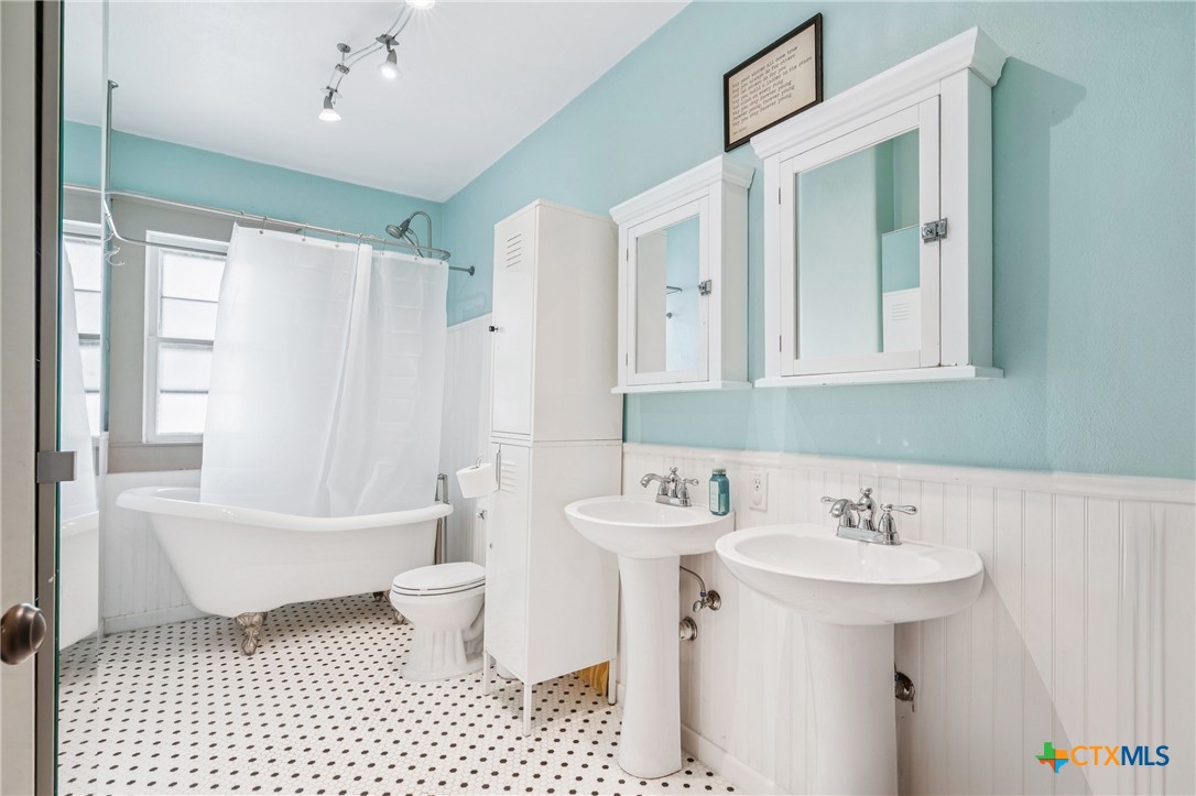 1004 Mitchell Street Gonzales, TX 78629 - Photo 30 of 46 a bathroom with a sink a toilet and shower