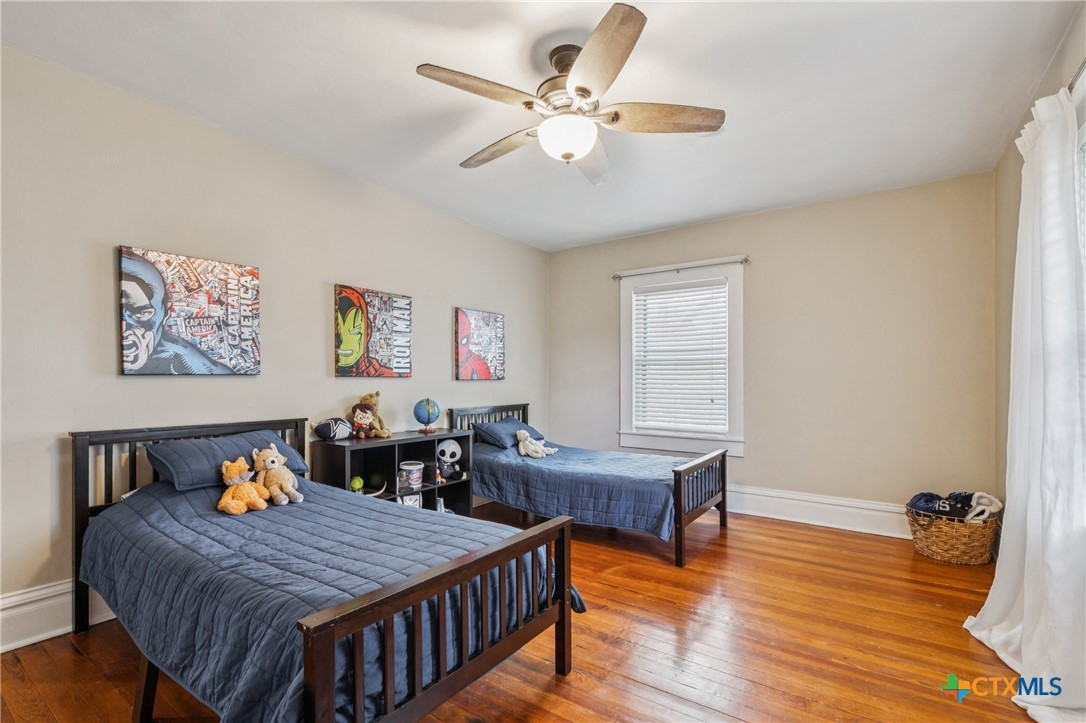 1004 Mitchell Street Gonzales, TX 78629 - Photo 31 of 46 a bed room with furniture and wooden floor