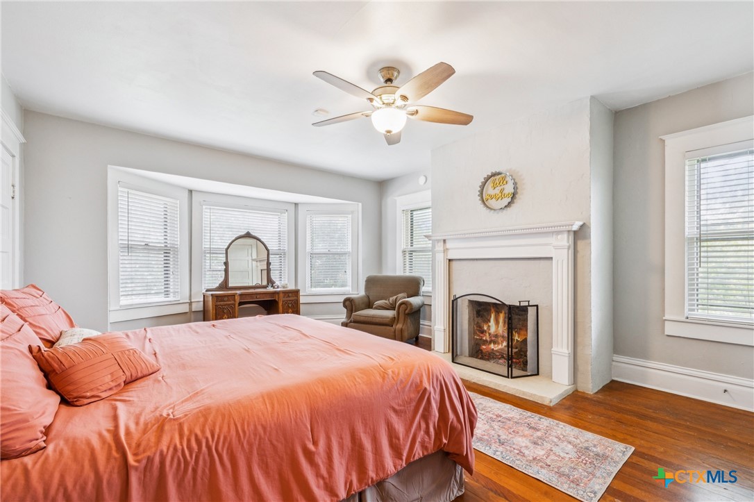 1004 Mitchell Street Gonzales, TX 78629 - Photo 32 of 46 a bedroom with a bed and a fireplace