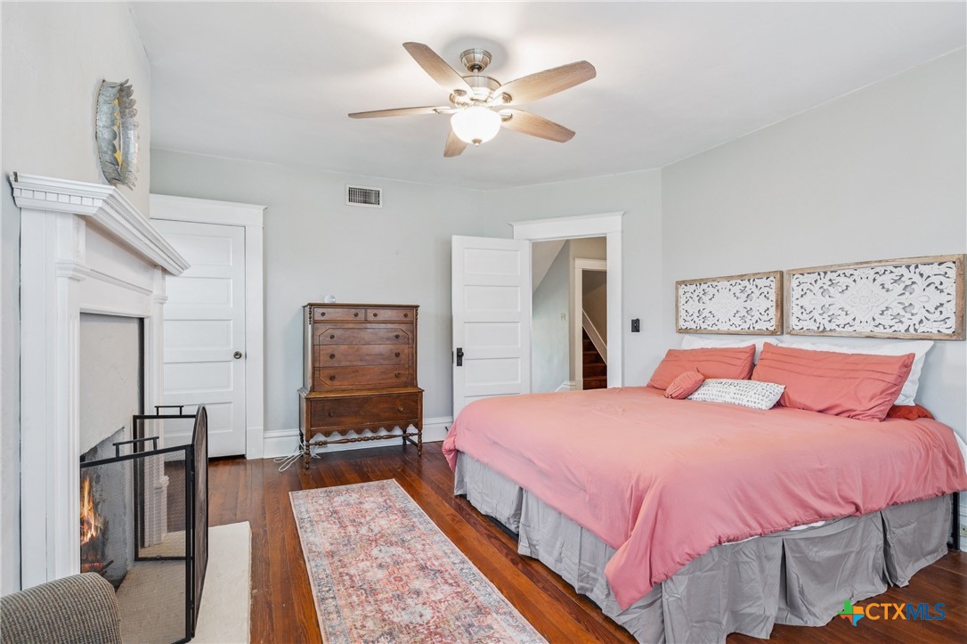 1004 Mitchell Street Gonzales, TX 78629 - Photo 33 of 46 a bedroom with a bed and a chandelier