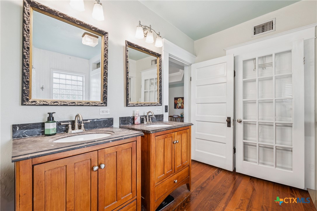 1004 Mitchell Street Gonzales, TX 78629 - Photo 34 of 46 a bathroom with a sink double vanity and a mirror