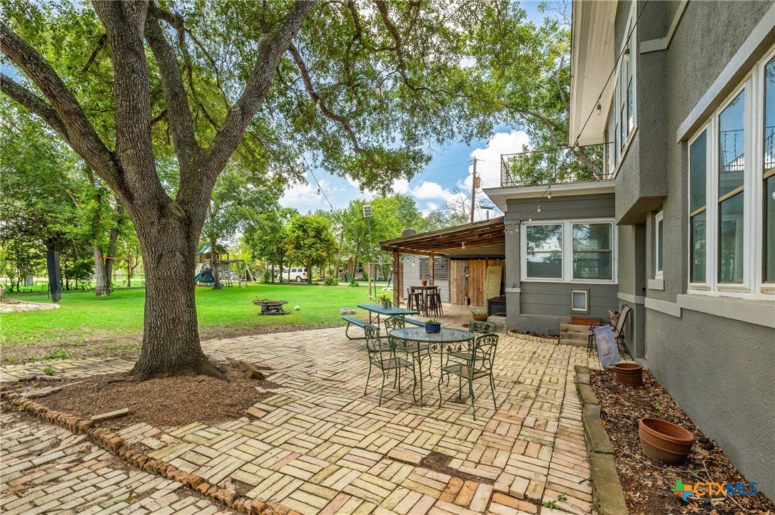 1004 Mitchell Street Gonzales, TX 78629 - Photo 40 of 46 a view of a house with backyard sitting area and garden