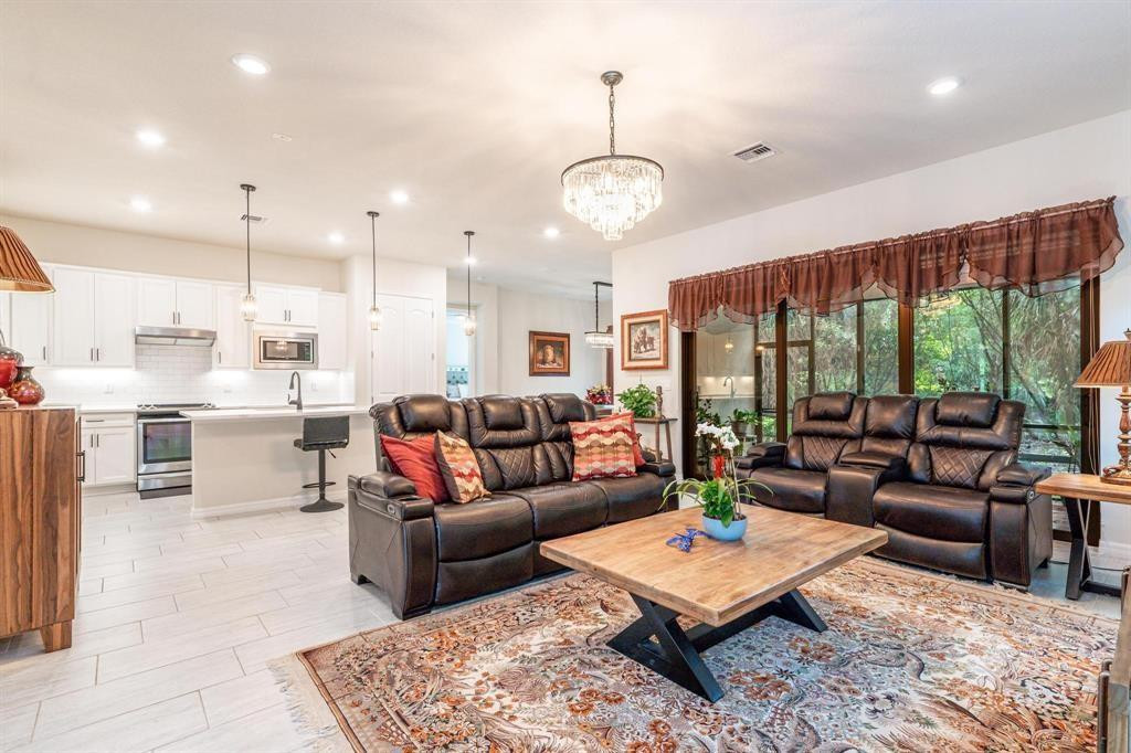 9208 Passiflora Way, Unit 102 Boca Raton, FL 33428 - Photo 11 of 30 a living room with lots of furniture and a large window