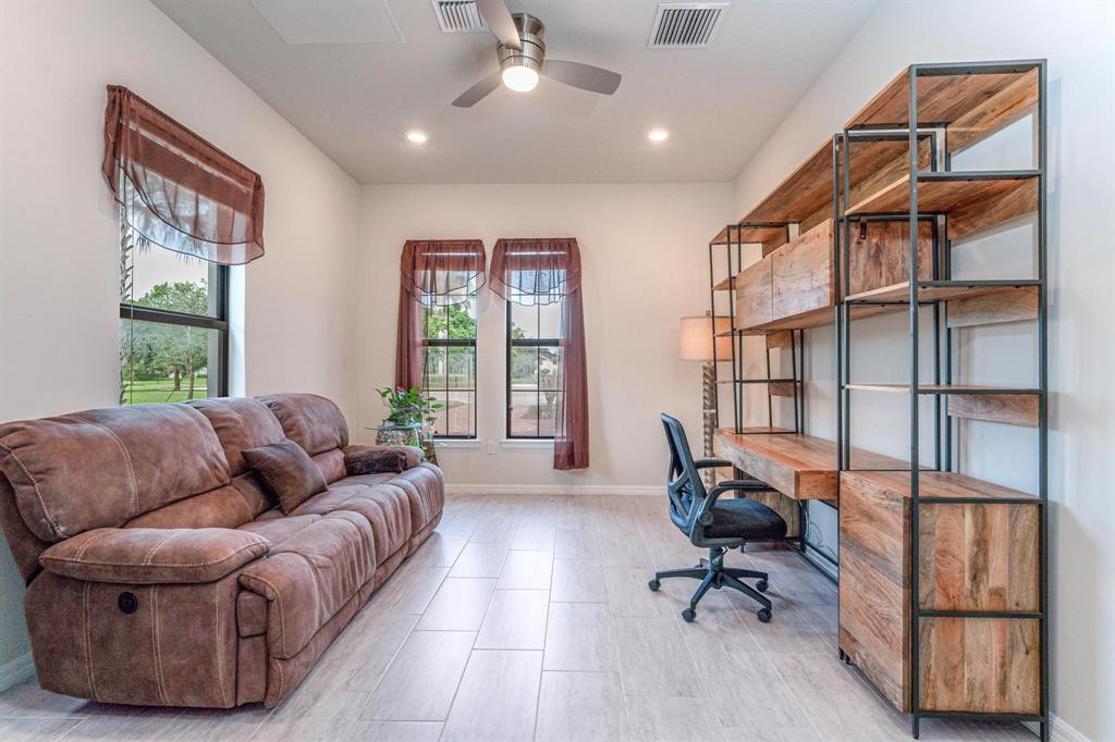 9208 Passiflora Way, Unit 102 Boca Raton, FL 33428 - Photo 13 of 30 a living room with furniture ceiling fan and a window