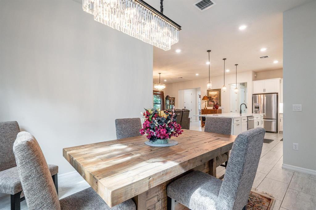9208 Passiflora Way, Unit 102 Boca Raton, FL 33428 - Photo 14 of 30 a view of a dining room with furniture and wooden floor