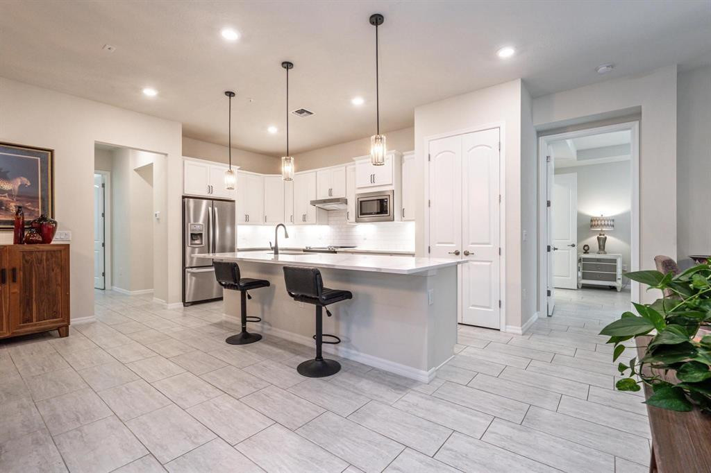 9208 Passiflora Way, Unit 102 Boca Raton, FL 33428 - Photo 16 of 30 a large kitchen with a table and chairs