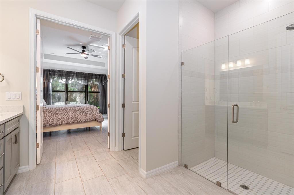 9208 Passiflora Way, Unit 102 Boca Raton, FL 33428 - Photo 20 of 30 a bathroom with a bathtub and a shower