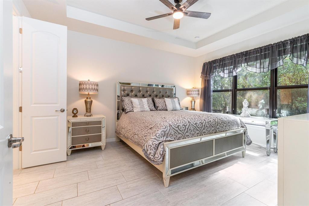 9208 Passiflora Way, Unit 102 Boca Raton, FL 33428 - Photo 21 of 30 a bedroom with a bed and large window