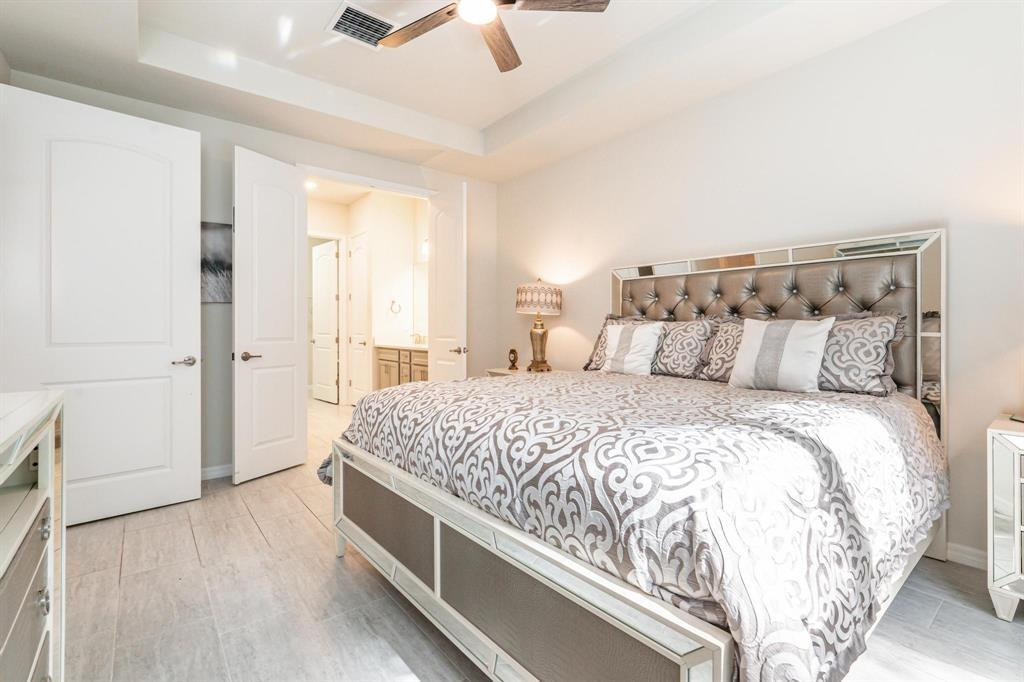 9208 Passiflora Way, Unit 102 Boca Raton, FL 33428 - Photo 22 of 30 a spacious bedroom with a bed and a cabinets