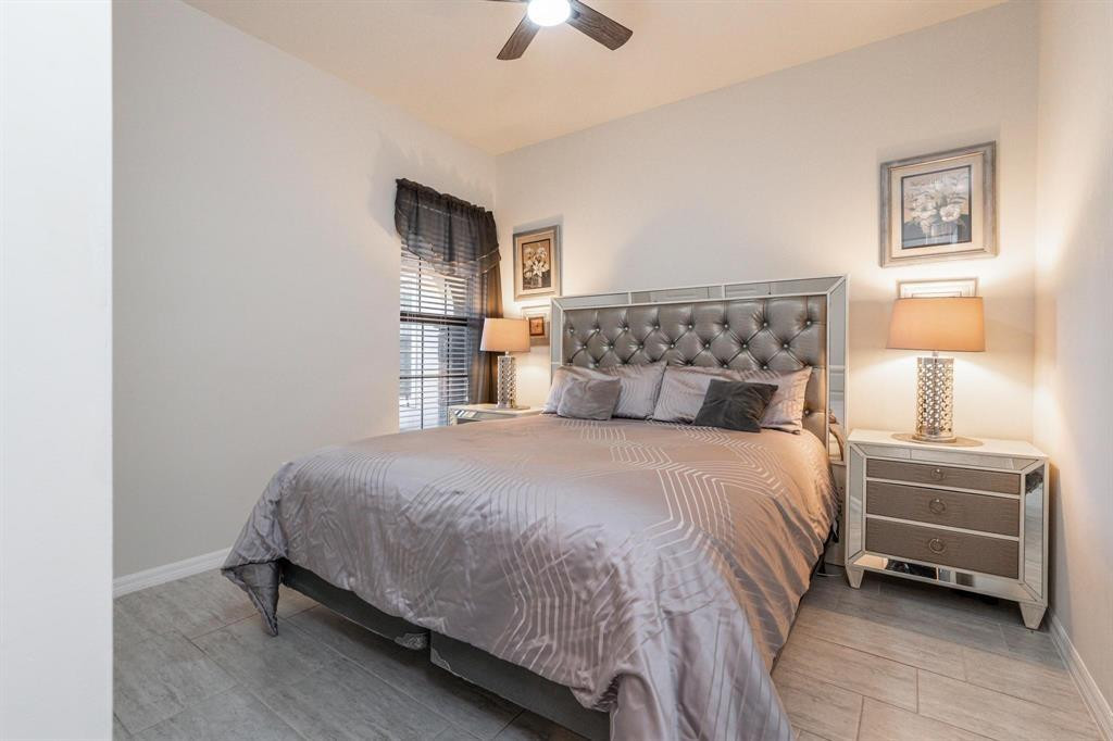 9208 Passiflora Way, Unit 102 Boca Raton, FL 33428 - Photo 24 of 30 a bedroom with a bed and a chandelier