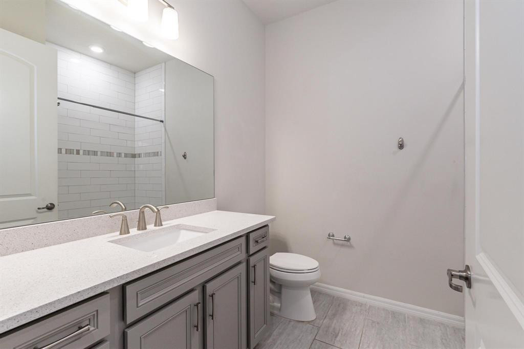 9208 Passiflora Way, Unit 102 Boca Raton, FL 33428 - Photo 25 of 30 a bathroom with a sink toilet and vanity