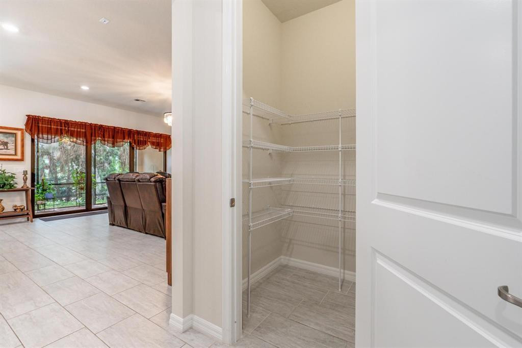 9208 Passiflora Way, Unit 102 Boca Raton, FL 33428 - Photo 26 of 30 a view of a hallway with wooden floor and door