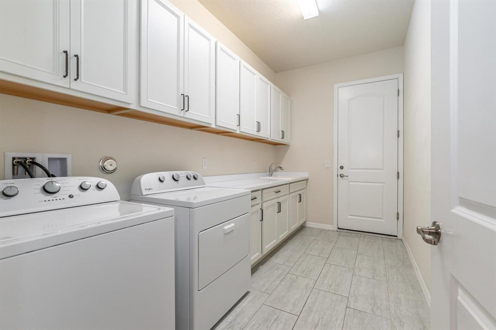 9208 Passiflora Way, Unit 102 Boca Raton, FL 33428 - Photo 28 of 30 a utility room with dryer and washer