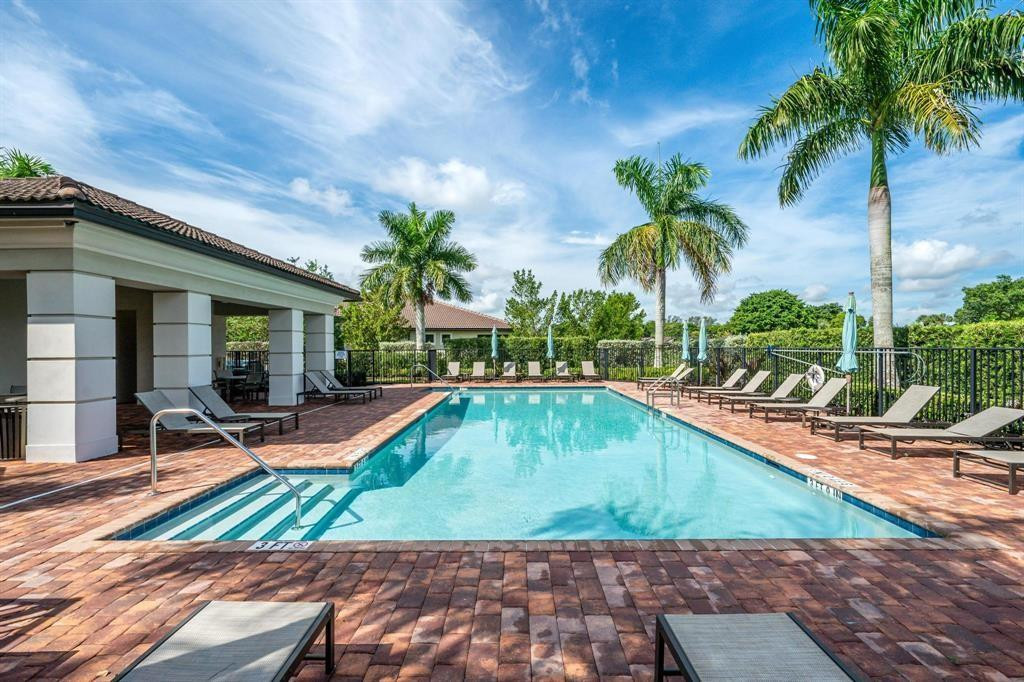 9208 Passiflora Way, Unit 102 Boca Raton, FL 33428 - Photo 29 of 30 a view of swimming pool with lawn chairs and plants