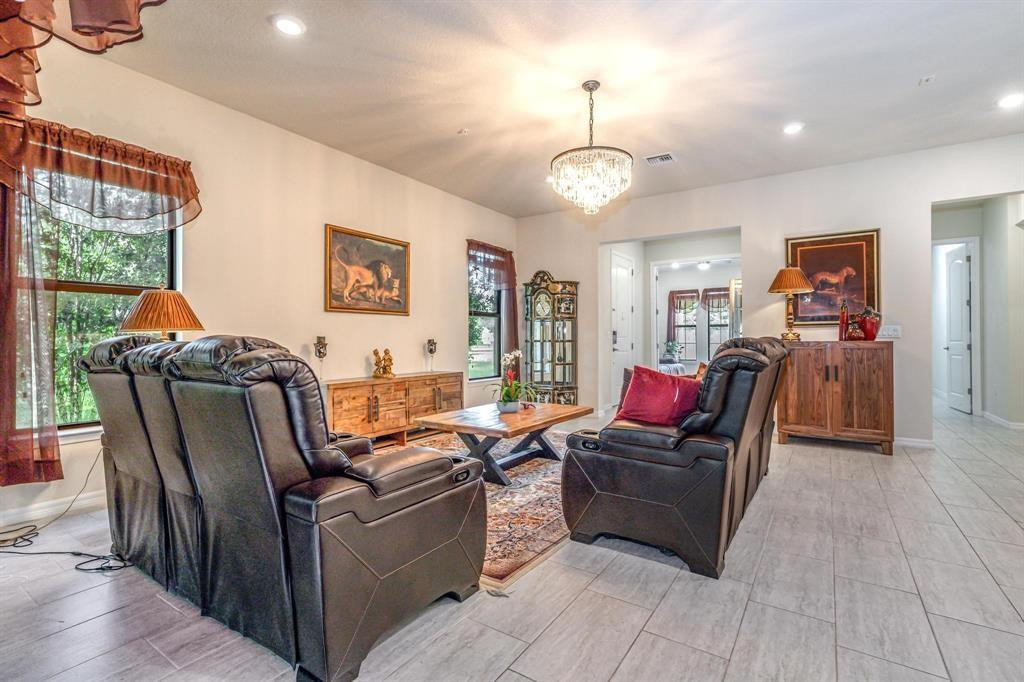 9208 Passiflora Way, Unit 102 Boca Raton, FL 33428 - Photo 7 of 30 a living room with furniture and a flat screen tv