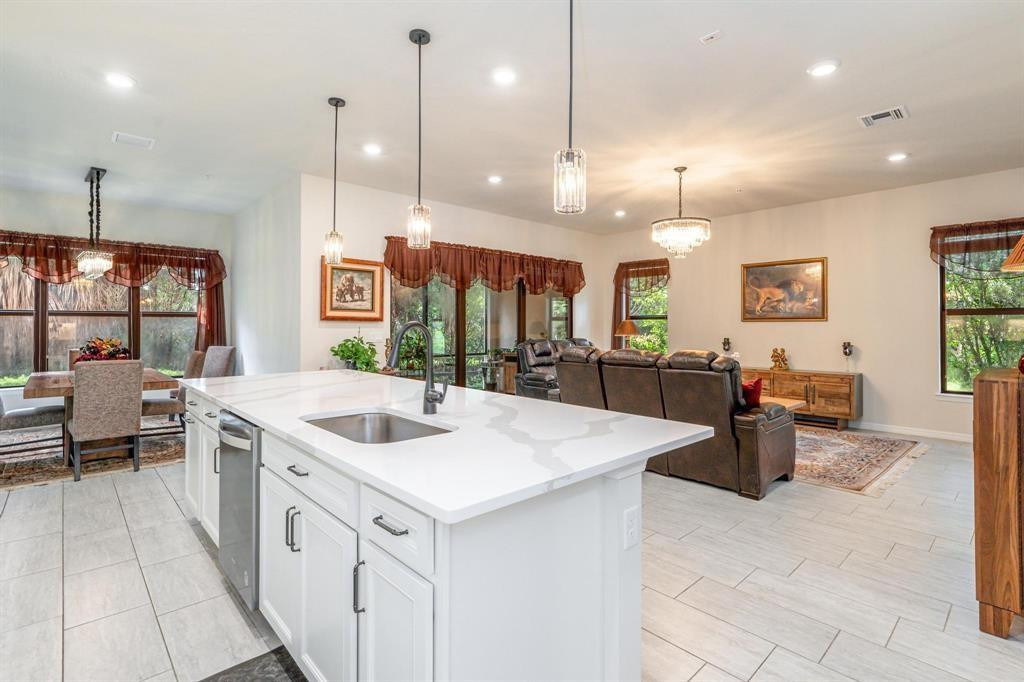 9208 Passiflora Way, Unit 102 Boca Raton, FL 33428 - Photo 8 of 30 a large kitchen with kitchen island a large counter space and stainless steel appliances
