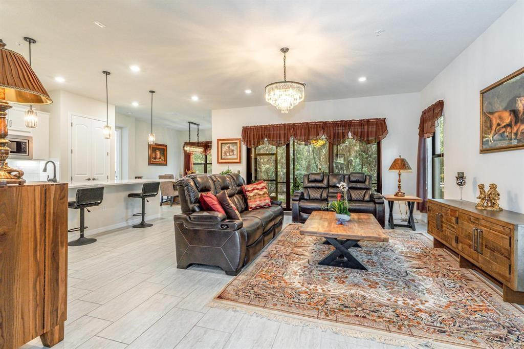 9208 Passiflora Way, Unit 102 Boca Raton, FL 33428 - Photo 9 of 30 a living room with furniture and a large window