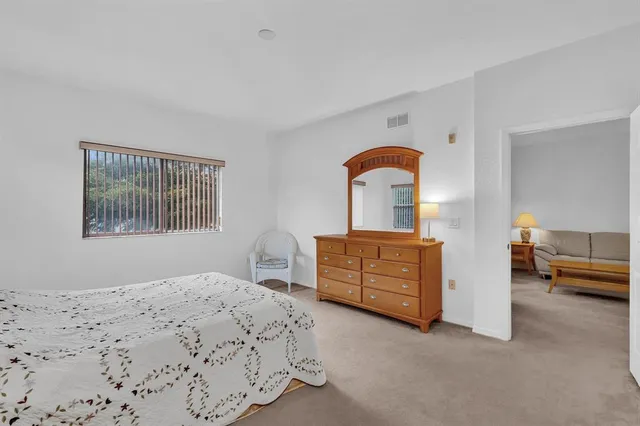 a bedroom with a large bed and a dresser