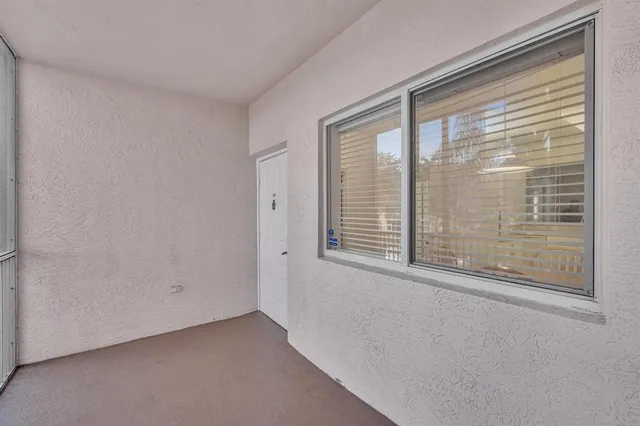 a kitchen with white cabinets sink and window