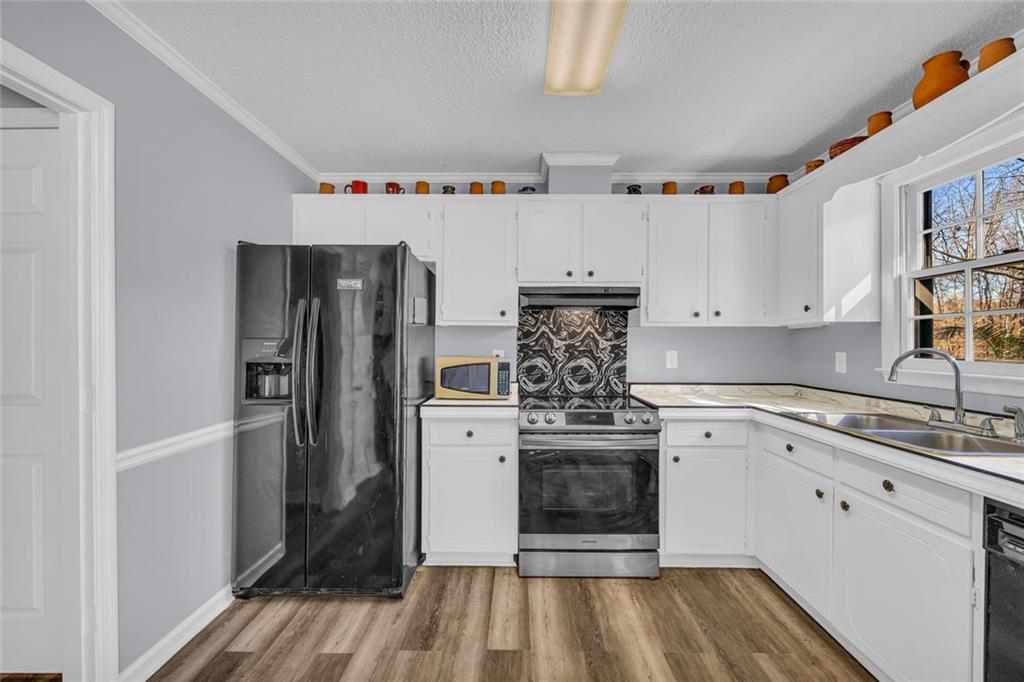 375 Brookstone Drive Athens, GA 30605 - Photo 13 of 70 a kitchen with a refrigerator sink and cabinets