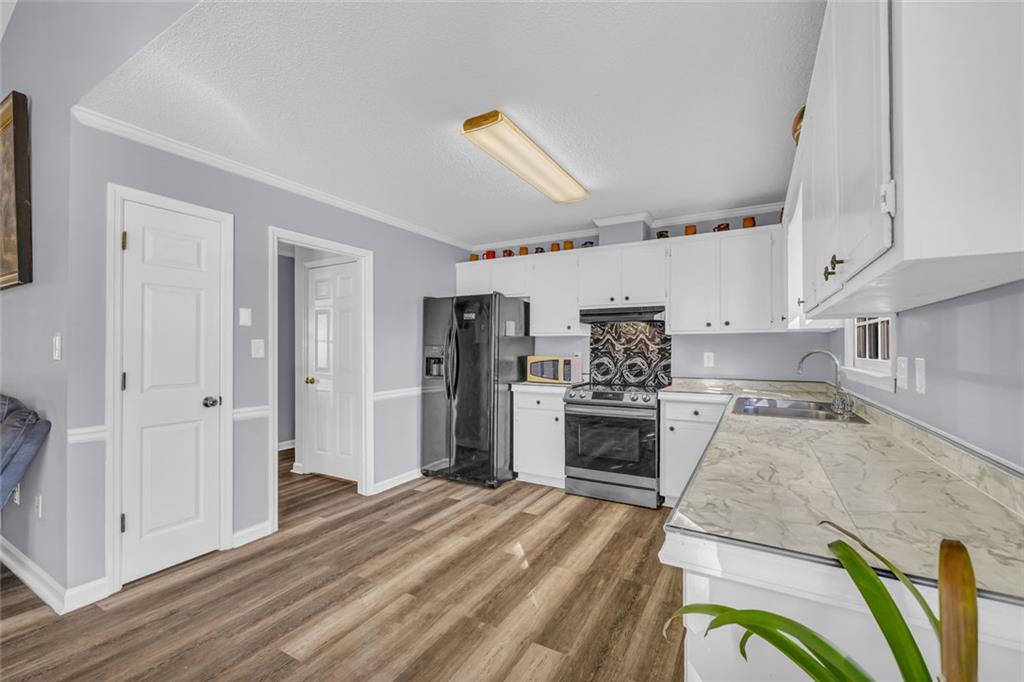 375 Brookstone Drive Athens, GA 30605 - Photo 16 of 70 a kitchen with stainless steel appliances kitchen island granite countertop a refrigerator and a stove top oven