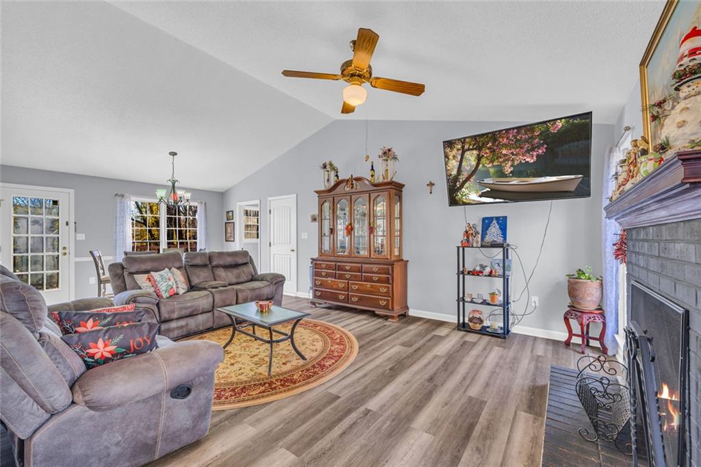 375 Brookstone Drive Athens, GA 30605 - Photo 3 of 70 a living room with furniture a fireplace and a flat screen tv