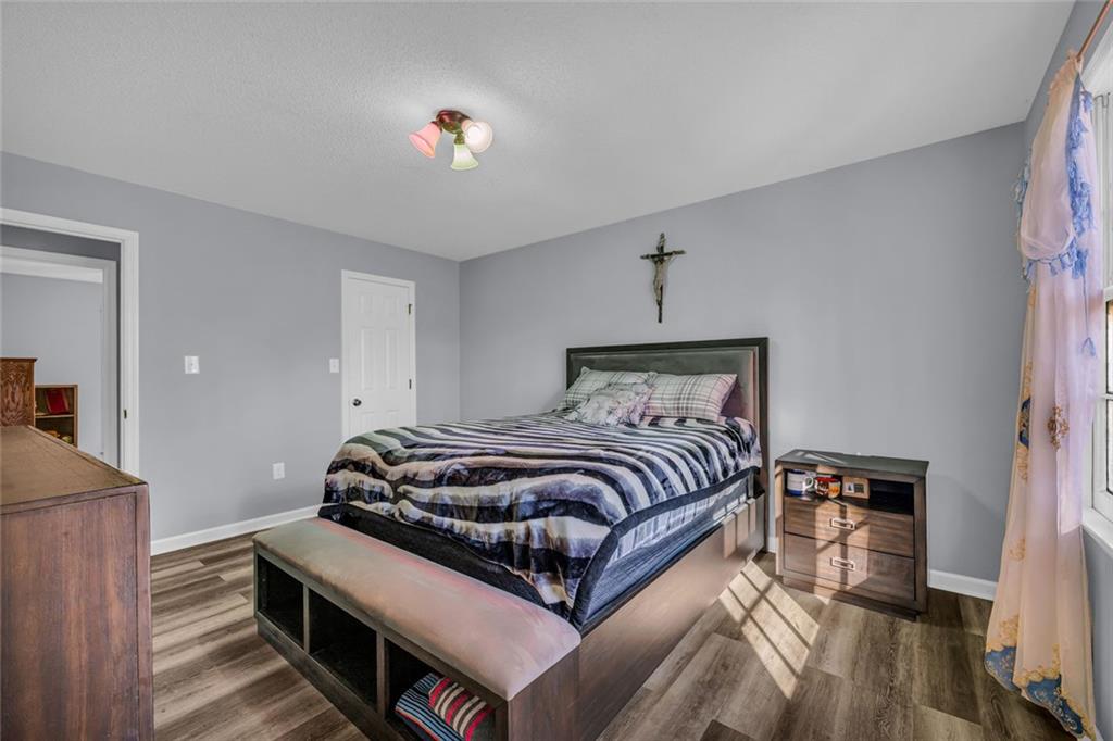 375 Brookstone Drive Athens, GA 30605 - Photo 62 of 70 a bedroom with a bed and a chandelier