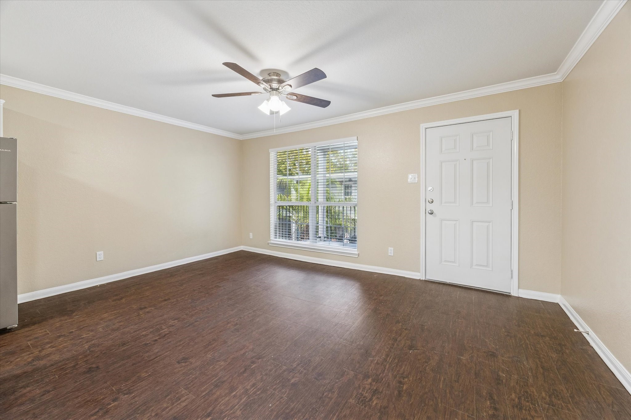 300 Pecore Street, Unit 19 Houston, TX 77009 - Photo 2 of 10 a view of an empty room with wooden floor and window