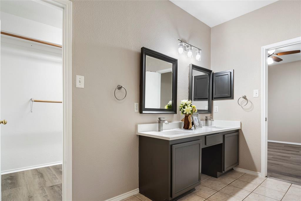 7900 Hidden Path Lane Denton, TX 76210 - Photo 17 of 25 a bathroom with a sink vanity and mirror