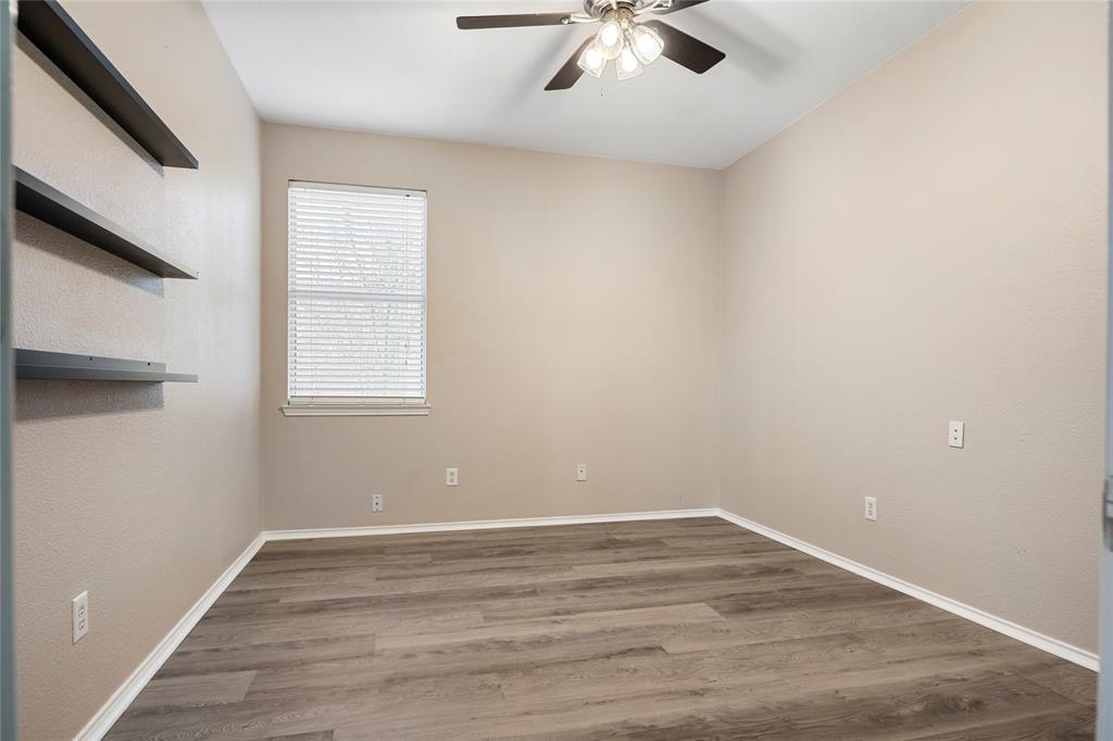 7900 Hidden Path Lane Denton, TX 76210 - Photo 19 of 25 an empty room with wooden floor and windows