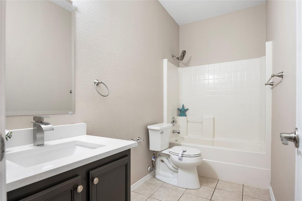 7900 Hidden Path Lane Denton, TX 76210 - Photo 21 of 25 a bathroom with a sink a toilet and shower