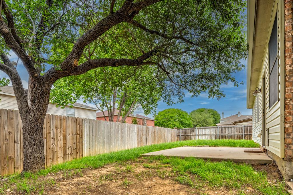 7900 Hidden Path Lane Denton, TX 76210 - Photo 23 of 25 a view of yard with large trees and wooden fence